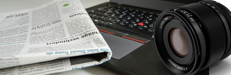 Earned Media for Businesses Image of newspaper computer and camera