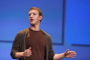 Mark Zuckerberg speaking with his hands held out.